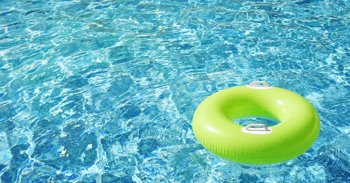 A tube floats alone in a pool. | Colling Gilbert Wright