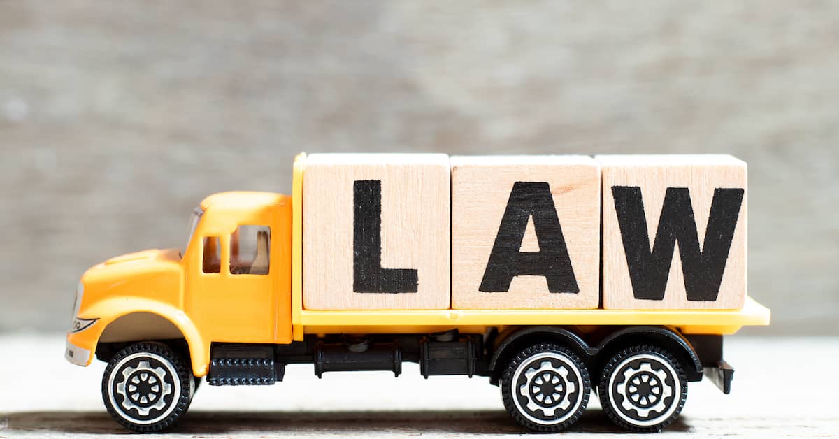 Toy commercial truck with blocks that spell "LAW." | Colling Gilbert Wright